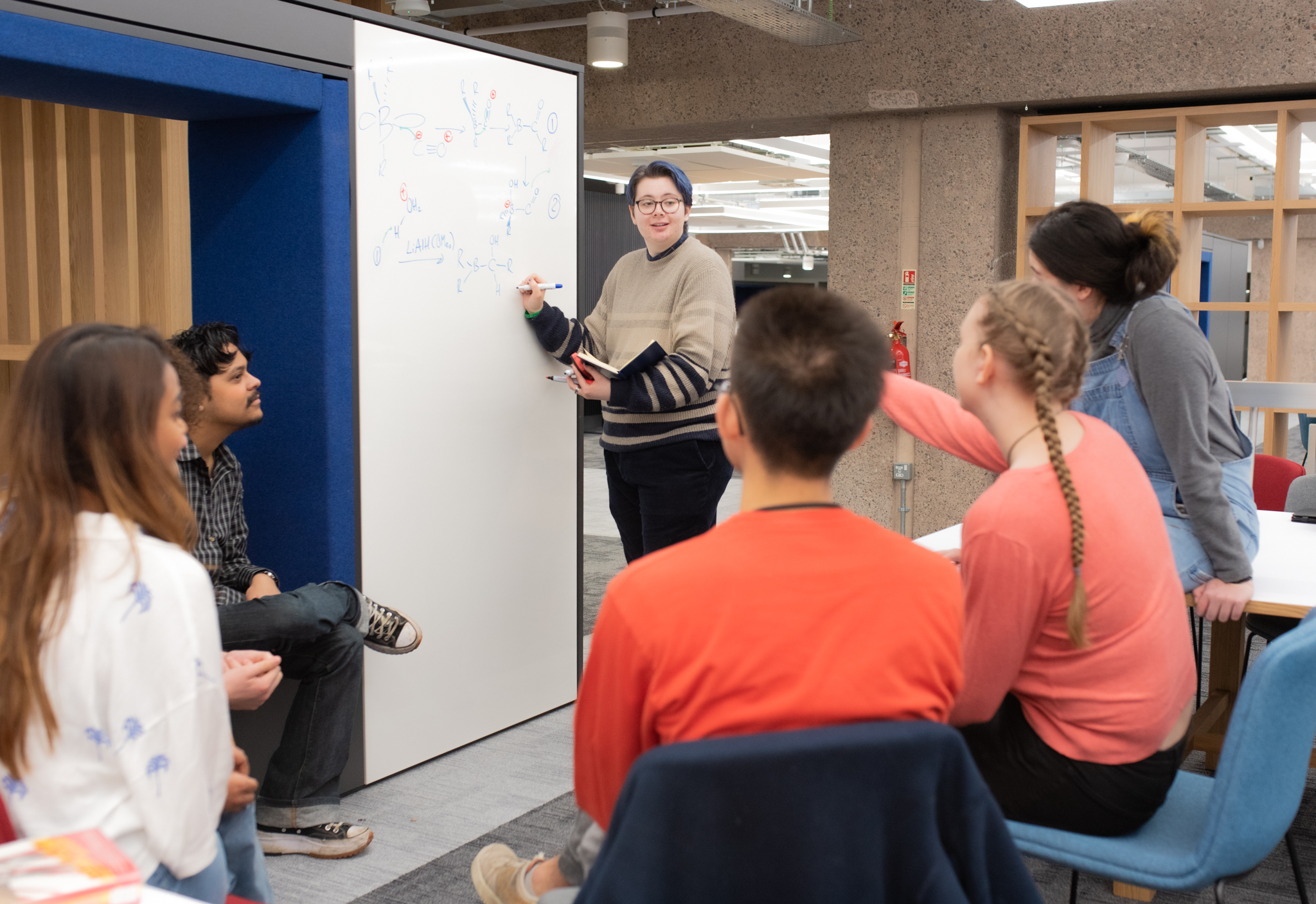 Group of students working together using a whiteboard